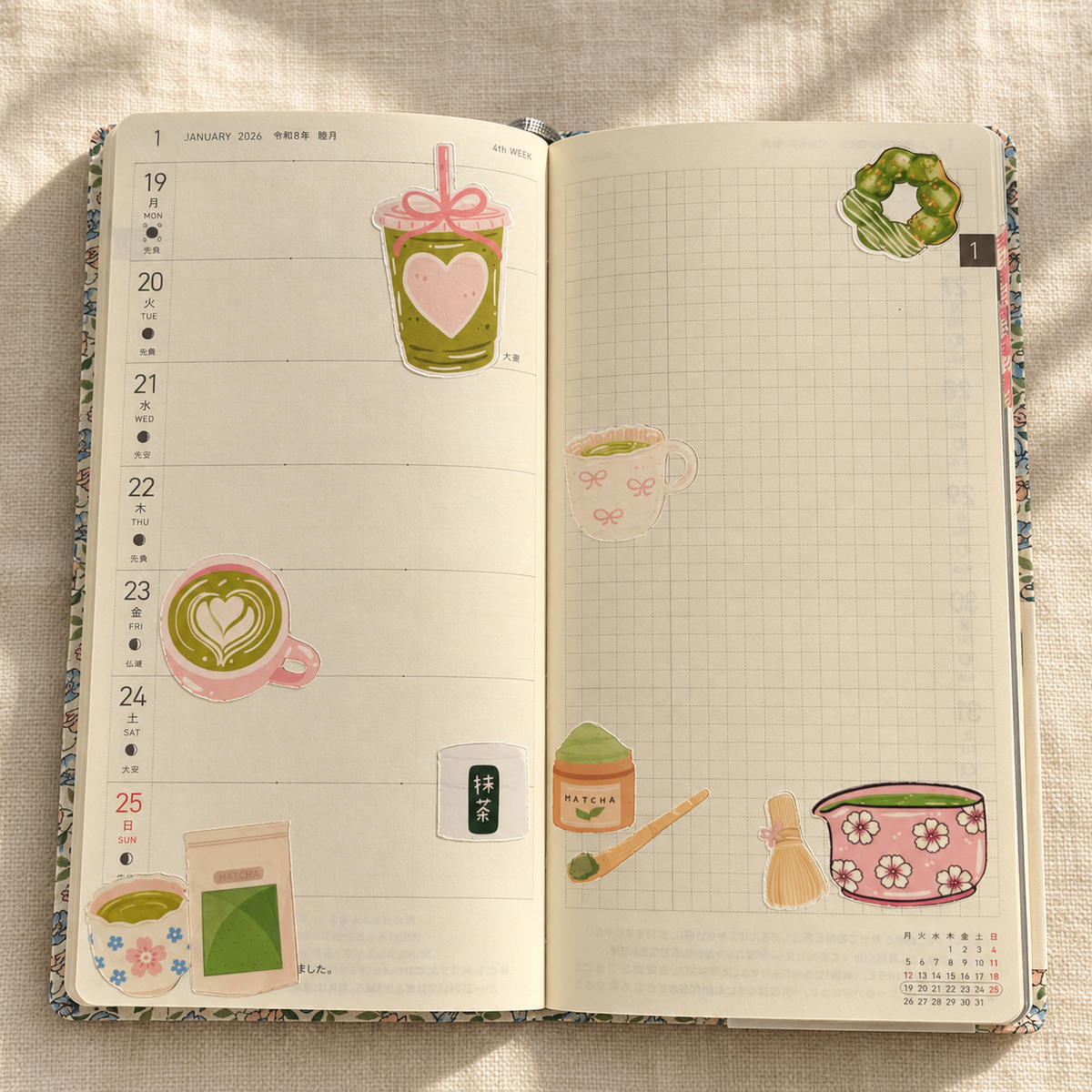 Open weekly planner decorated with pink and green matcha paper stickers.